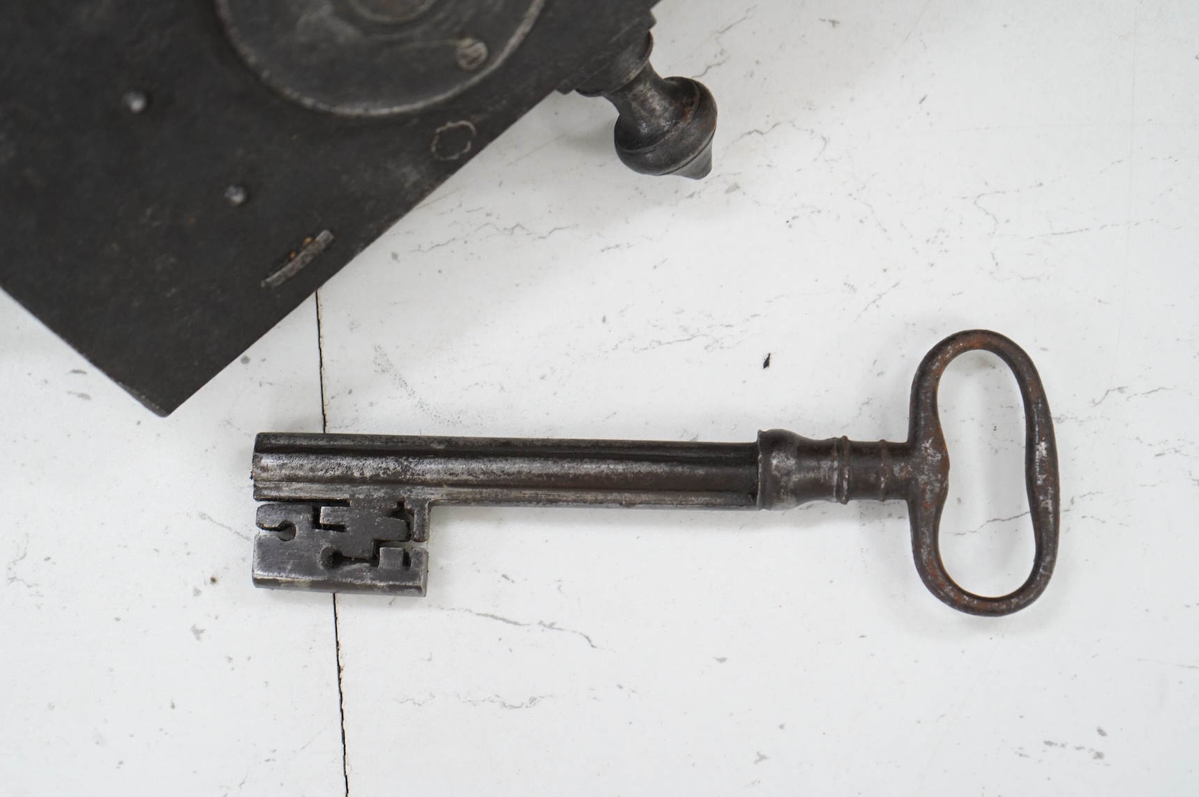 A 17th century steel door lock and key, lock 24cm wide.